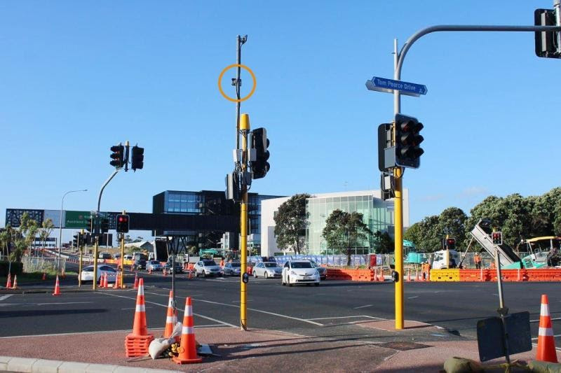 Busy intersection with construction site and Smart Radar on traffic lights