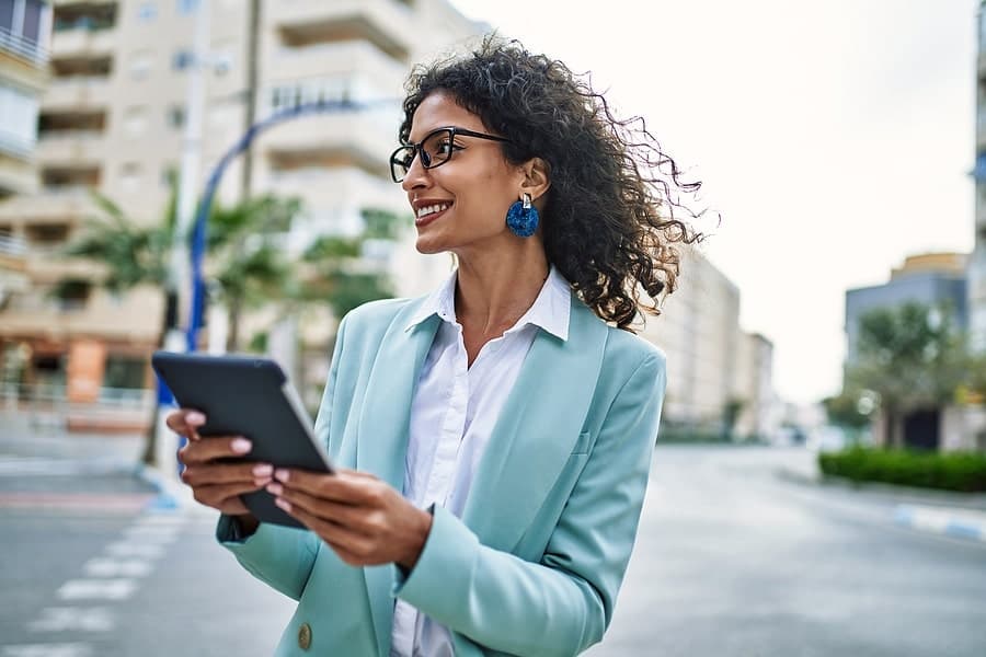 Professional woman using a smart city device to navigate streets