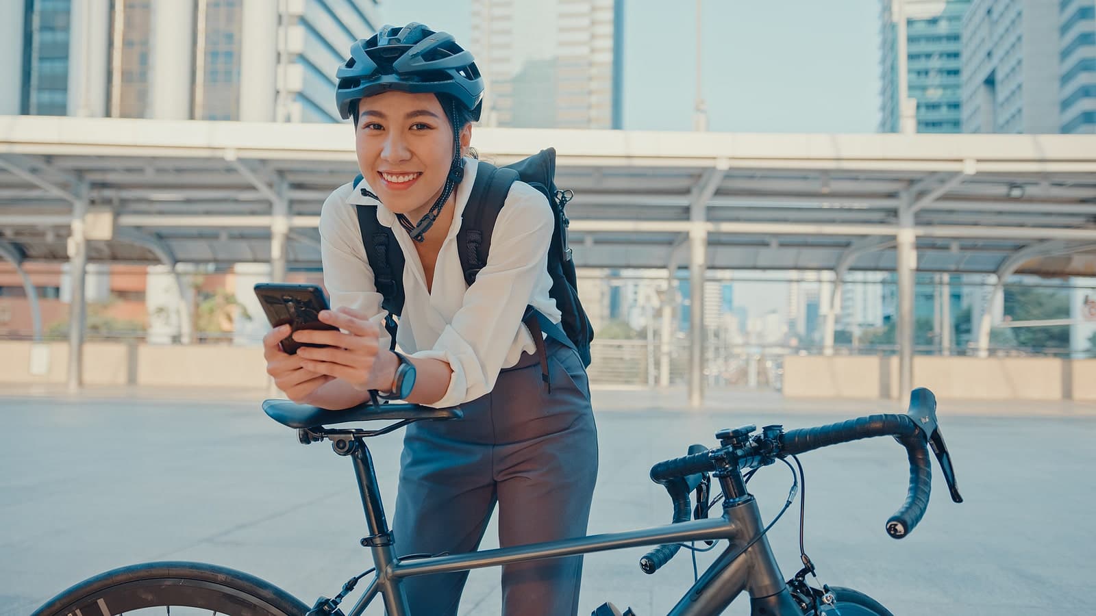 Woman standing by her bike on the way to work